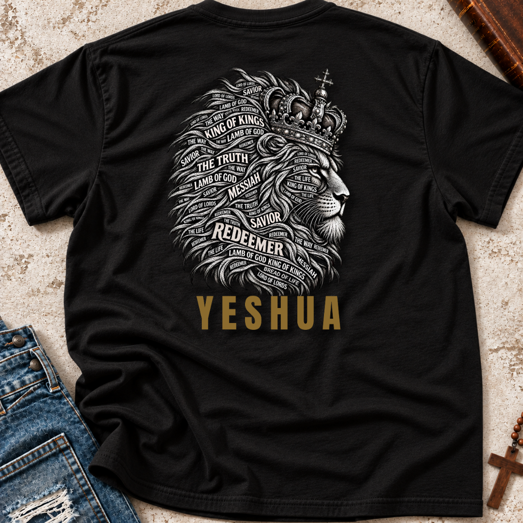 Black shirt laid out amongst props in the corners of the image with a lion graphic that has words of Christ's identity inlaid in the main and the word "Yeshua" printed below in gold lettering