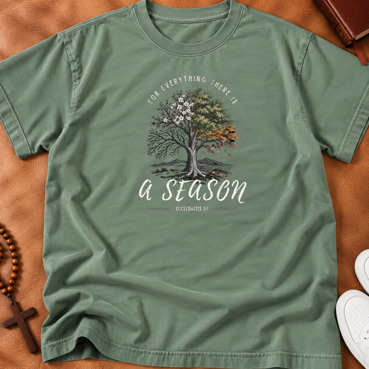 Sage shirt with a tree portraying all the seasons with the words arched above it "for everything there is" and beneath the tree "a season' Ecclesiastes 3:1 
