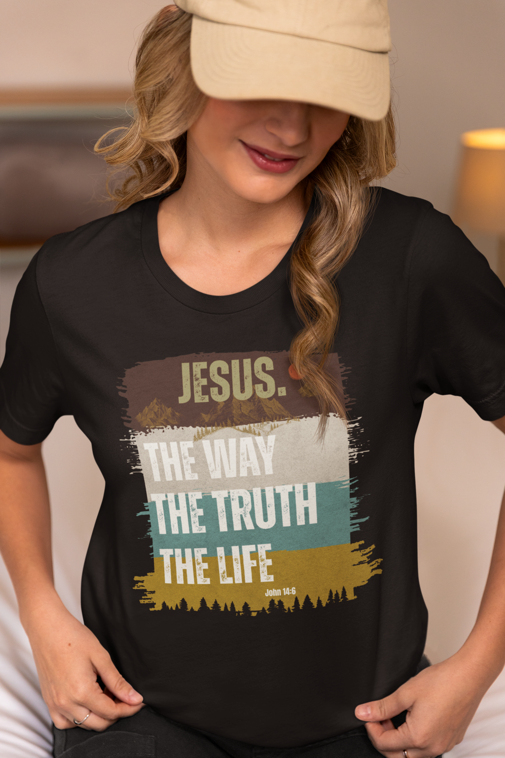 A woman wearing a black Christian graphic t-shirt with a distressed multi-colored print that reads 'JESUS. THE WAY THE TRUTH THE LIFE' and 'JOHN 14:6'.
