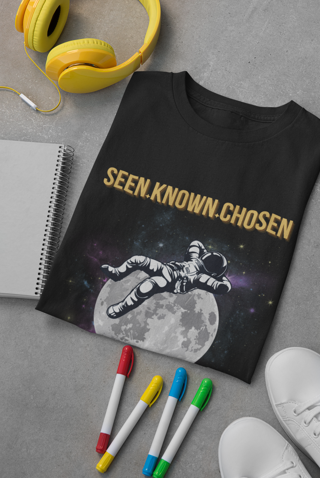 A black graphic faith based t-shirt featuring the text 'SEEN.KNOWN.CHOSEN'