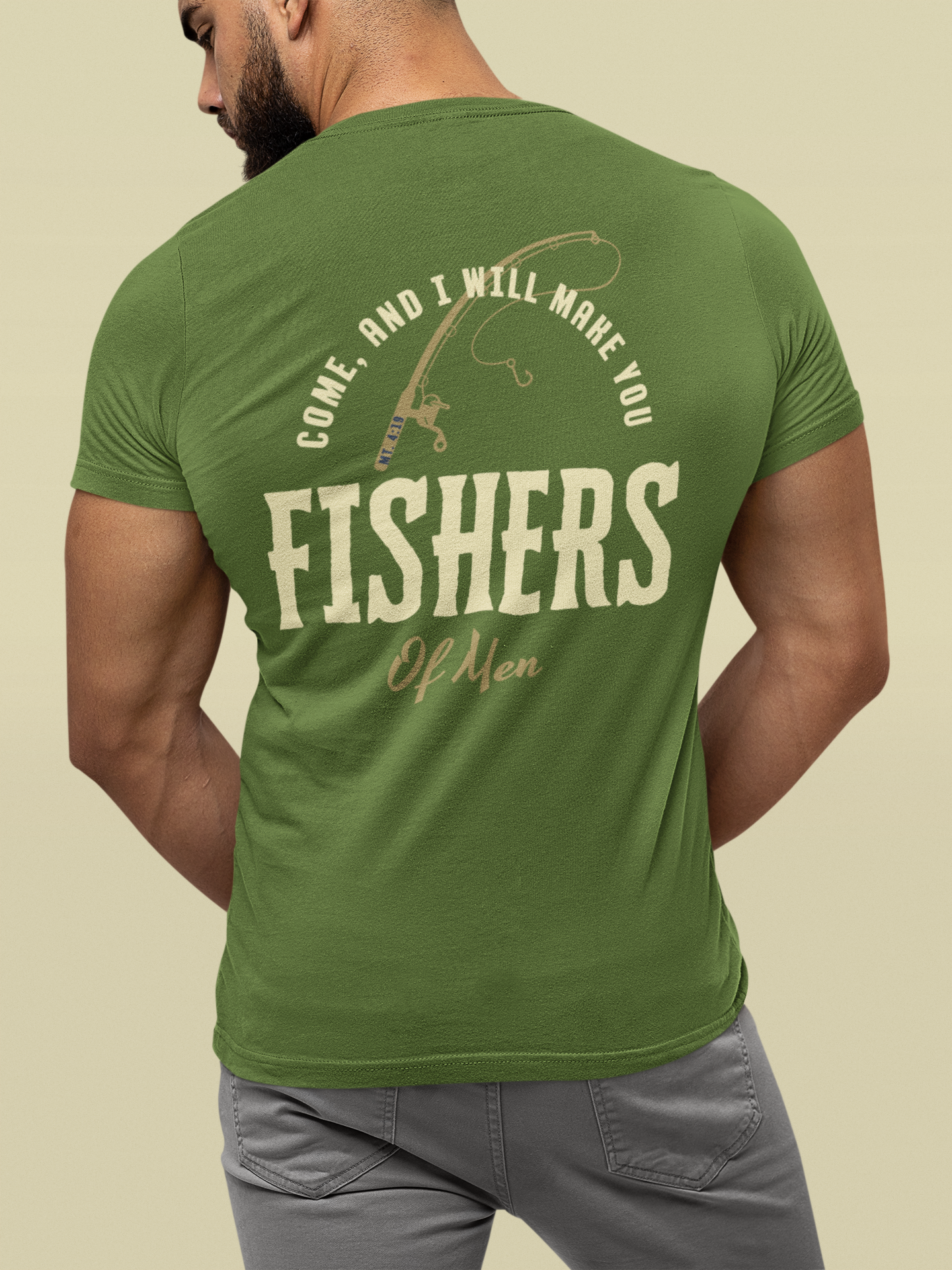 A man wearing a green t-shirt from the back, featuring a military green Christian graphic that reads 'COME, AND I WILL MAKE YOU FISHERS OF MEN' with a fishing rod illustration.