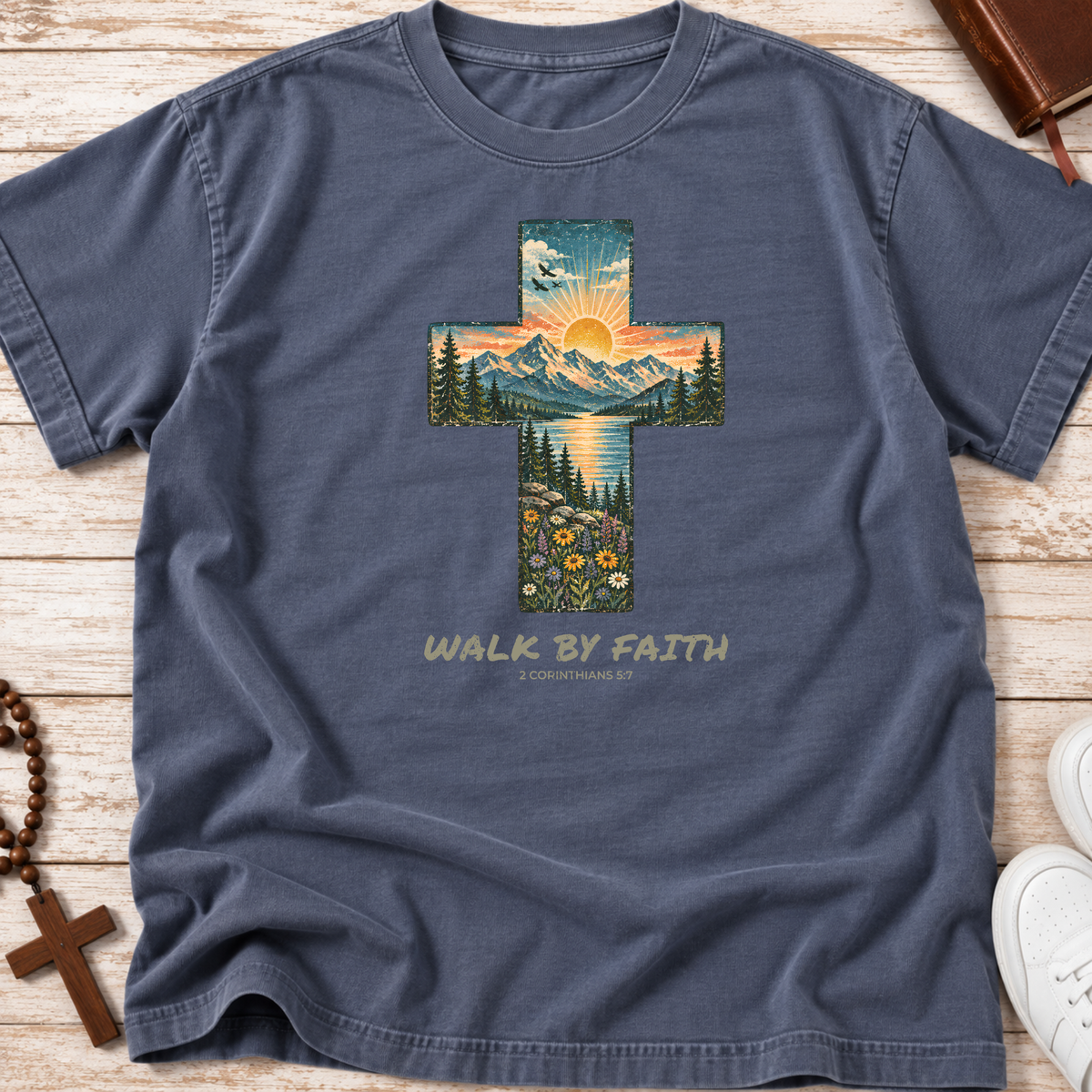 Comfort Colors denim shirt that has a cross with a sunset landscape inlaid and the words 'walk by faith' and '2 corinthians 3:7'