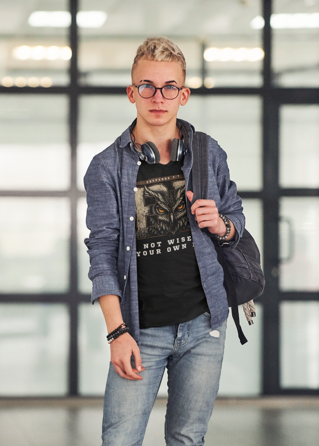 A young man standing wearing a layered long sleeve shirt with a Be Not Wise Christian graphic tee underneath featuring Proverbs 3:7