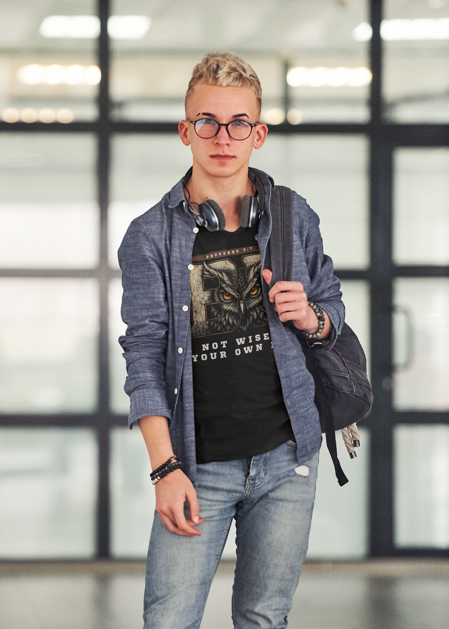 A young man standing wearing a layered long sleeve shirt with a Be Not Wise Christian graphic tee underneath featuring Proverbs 3:7