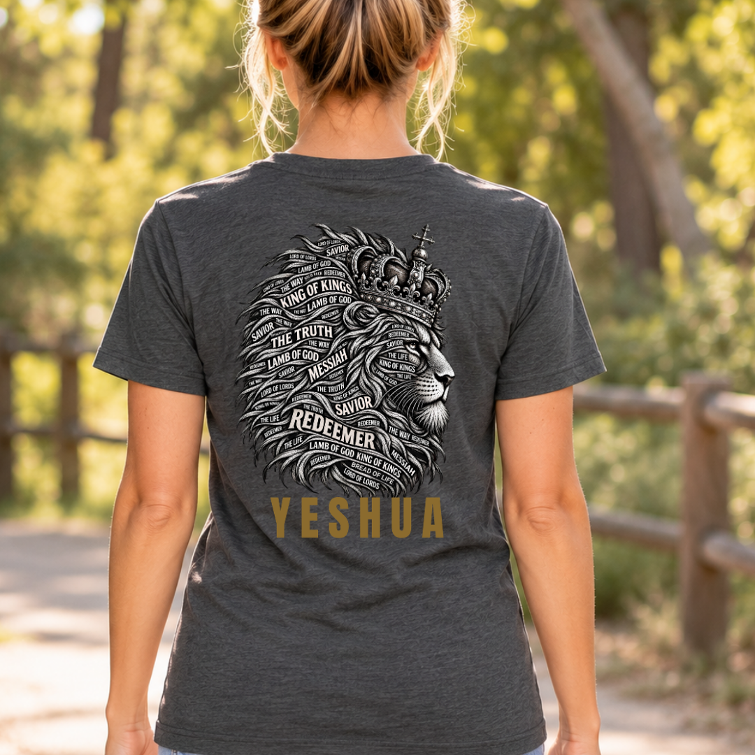 a woman wearing a dark heather grey Christian graphic shirt with a lion graphic that has words like "redeemer, king of kings, the truth" inlaid in the main with gold lettering below the lion that says "Yeshua"