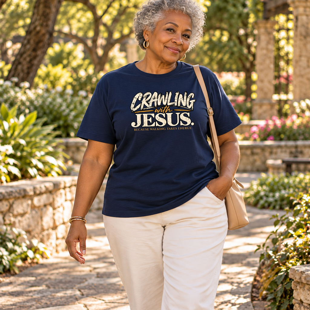 a woman walking in a park wearing cream pants and a navy Christian t-shirt by SeedSowerGraphics that says "crawling with jesus' becuase walking takes energy.