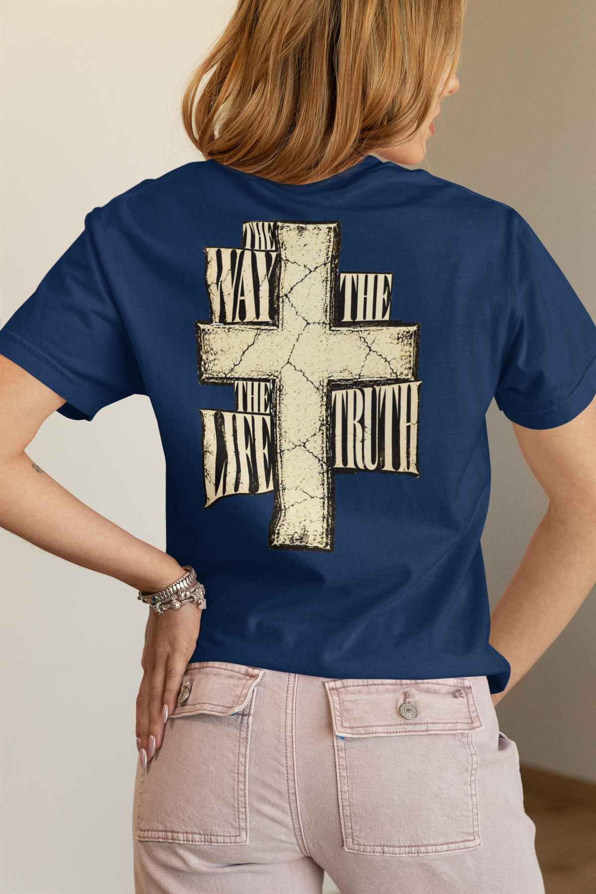 woman wearing a navy christian graphic tshirt that says, 'the way the truth the life'